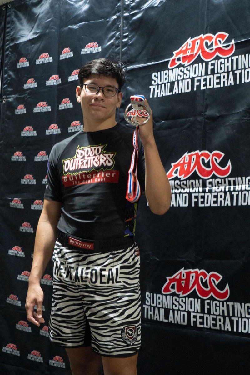 A Gato Studio BJJ competitor with a medal at an ADCC Submission Fighting Thailand Federation event